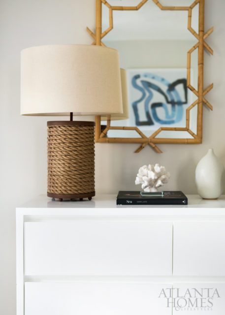 In the guest master bedroom, an Arteriors lamp and Serena & Lily mirror embrace the tropical environs.