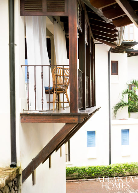 Restoration Hardware sheers mix with Williams-Sonoma Home chairs on the dining terrace.