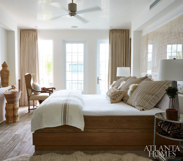 In the upstairs bedroom, Mayers didn’t want bright colors to take away from the serene palette. She chose an assortment of oatmeal tones, adding fun elements such as fur-trimmed pillows and an antique lumbar pillow with hints of color.
