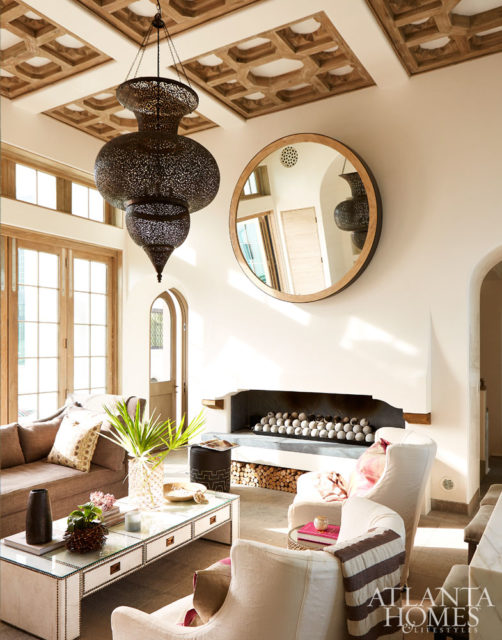 A grey Lee Industries sofa and textured throw pillow add subtle yet substantial details to the light-drenched living room.