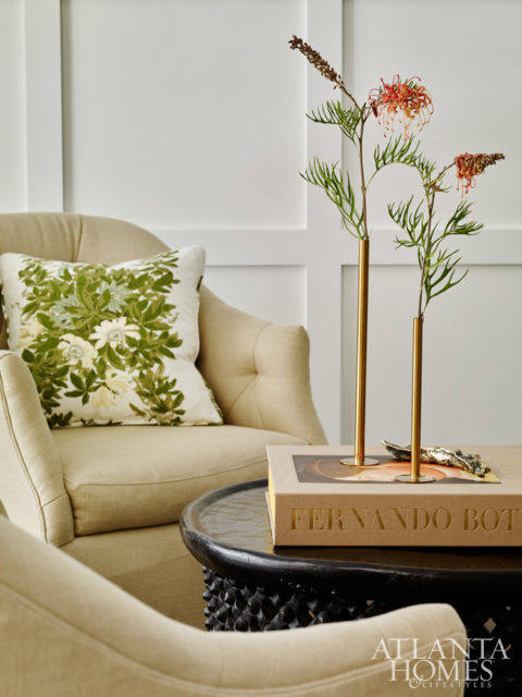 Adjacent to the breakfast nook is the new keeping room; Lowrey added paneled walls that conceal a built-in desk. Brass bud vases, Townhouse by Robert Brown. Throw, Ochre at R. Hughes. Book, Max & Co.