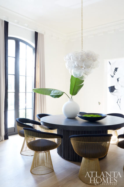 Large-scale dentil molding puts a twist on traditional in the chic dining room. Chandelier, Oly. Round table, Bradley.