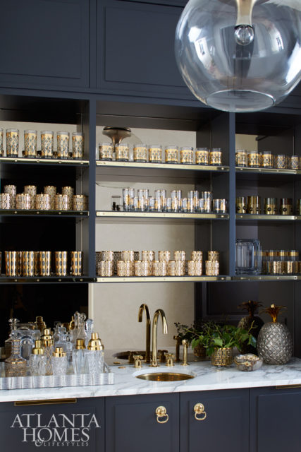 A bar features an array of vintage glasses from Turner’s own collection.