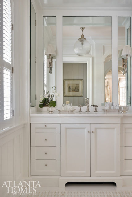 The master bathroom was completely gutted and now sparkles with gleaming tile, white cabinetry and mirrored surfaces and furniture.