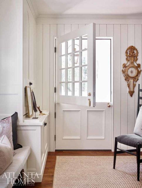 A Dutch door offers a casual entrance from the driveway—via a small sitting porch—into one of the renovated home’s two mudrooms. Originally part of the home’s kitchen, this space speaks to the modern family’s desire to live more casually. The mudroom, which also contains a powder room, opens to the formal dining room as well as to the butler’s pantry, kitchen and breakfast nook.
