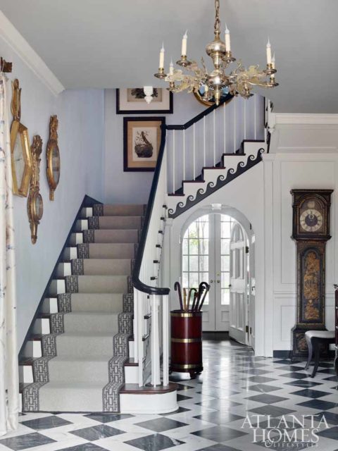 Designed on an axis that leads the eye from the entrance to views of the rear courtyard’s infinity-edge pool and beyond, this three-story stairwell was transformed from a dark wood stain to a high-contrast palette thanks to a scroll on the stair skirt board Lanham painted black-and-white and a dynamic floor pattern from Renaissance Tile & Bath.
