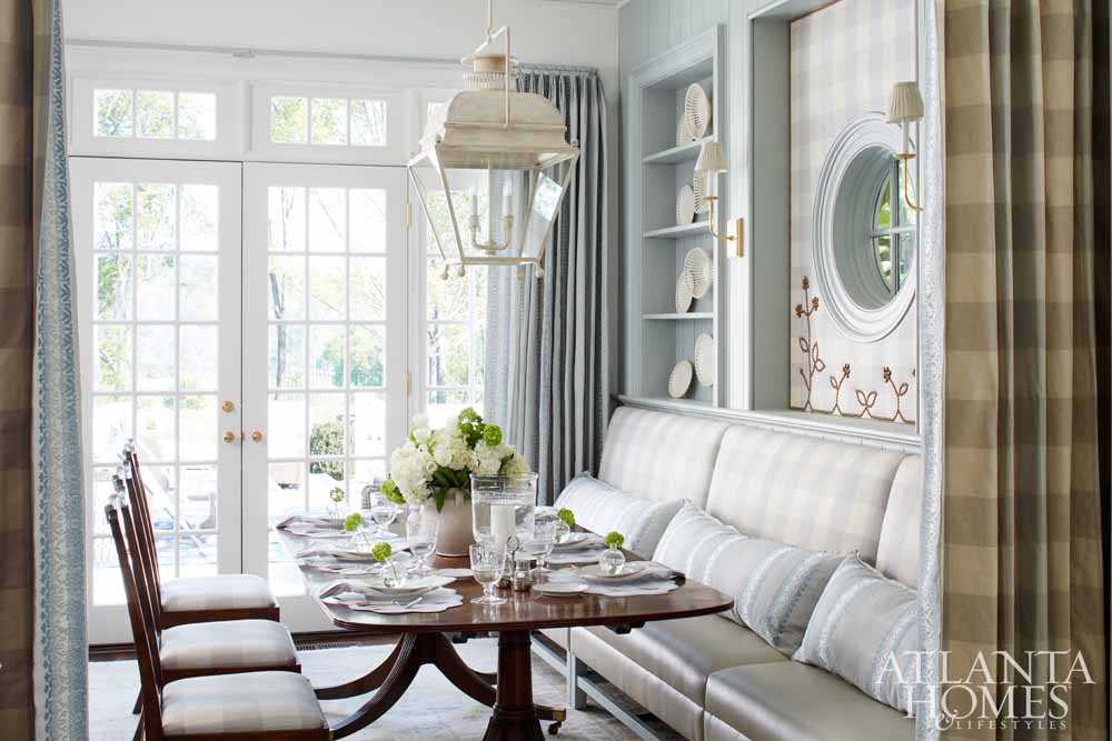 Dining area with pale blue walls, white lantern, banquette seat, dining table, Hepplewhite chairs