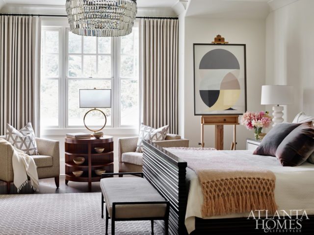 An abstract artwork from Stanton Home Furnishings rests on an easel from the Buskos’ own collection in the serene master bedroom. The bed, nightstands, hide bench, round table and chairs are Bernhardt. The lamps and chandelier are through Stanton Home Furnishings. Bed linens and pillows, Peacock Alley. Pottery, B.D. Jeffries.