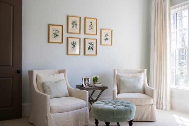 The master bedroom includes a comfortable space to curl up with a book and take in the view outside. It’s accented with botanical prints the homeowner picked up at Scott Antique Market. “She favors neutrals and wanted the master bedroom to be an oasis of calm and relaxation,” says Ghegan.