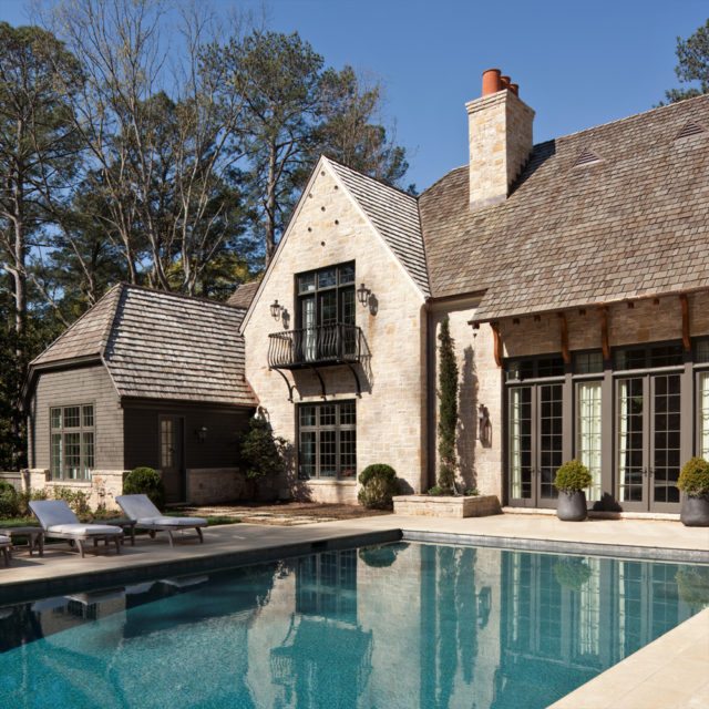 This Atlanta home’s rear courtyard boasts a long pool flanked by a lawn that beautifully frames the stone and Shaker pool house at the end of the terrace. Image courtesy of Images Publishing