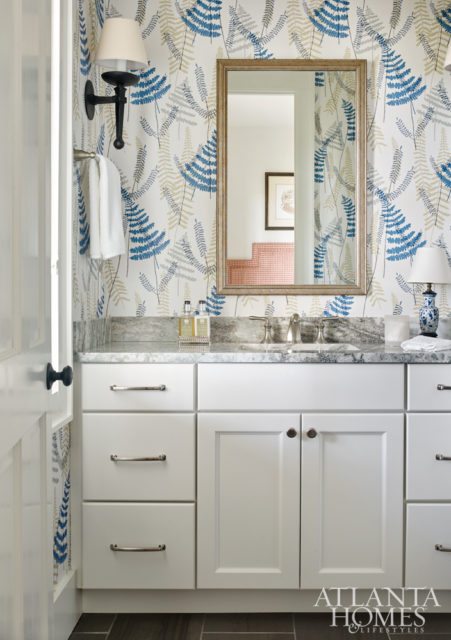 Scion wallpaper in a guest bathroom gives off a whimsical note with its dancing ferns, making it perfect for visiting grandchildren and adults alike.