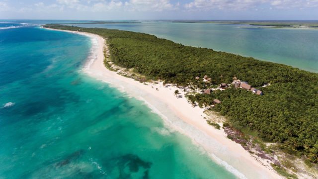 With the small cluster of villas at Mukan barely visible, an eagle’s view shows the resort’s lush surroundings and proximity to both the Lagoon and the sea.
