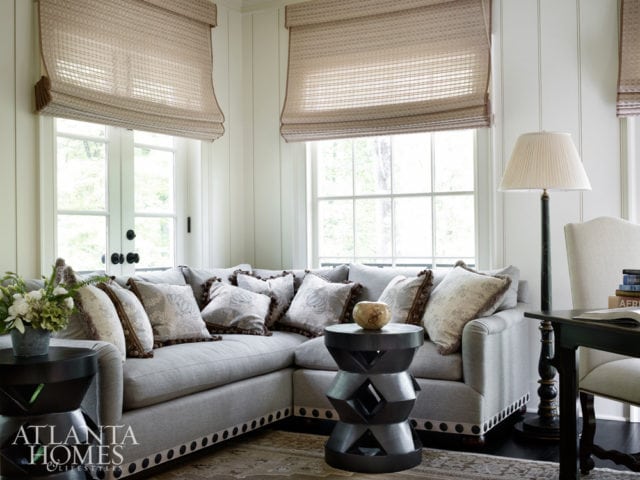 NAILHEAD TRIM Oversize nailheads add a striking detail to an L-shaped sofa. Design by Jackye Lanham