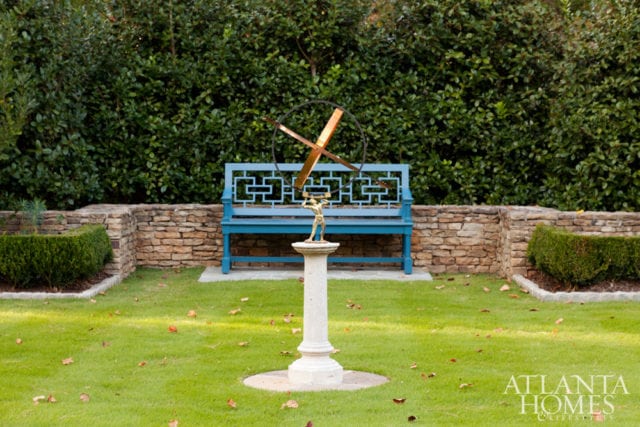 GARDEN STATUARY Creating garden rooms beckon visitors to enjoy the great outdoors. In this landscape, a punchy-hued bench and an armillary sundial mounted on a pedestal contribute to a sense of prominence and place. Design by John Howard