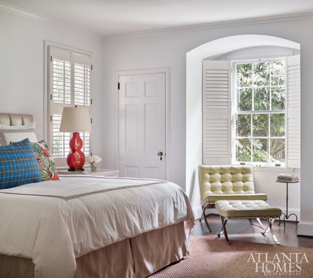 The master bedroom straddles the line between masculine and feminine thanks to a Mies van der Rohe-designed Barcelona chair from Knoll and a tartan toss pillow.