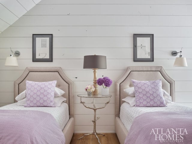 Beyond a sliding barn door is the guest suite, which beguiles with touches of lavender and architectural drawings from John’s university days.