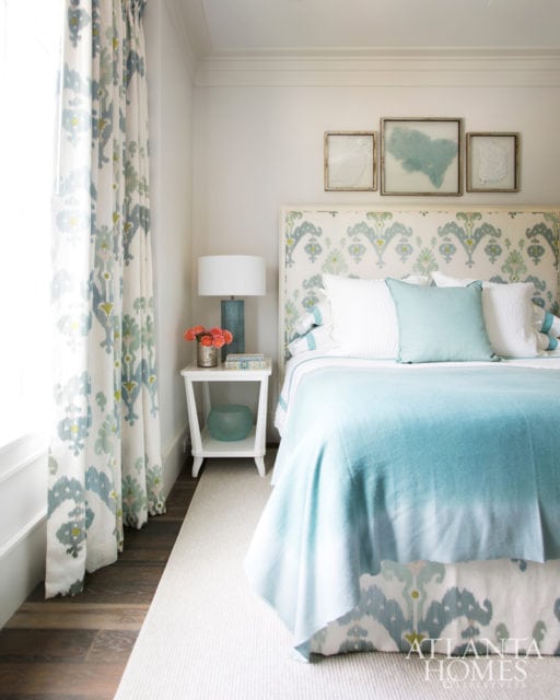 A guest bedroom’s calming color scheme is punctuated with playful pattern on the draperies, headboard and dust skirt.
