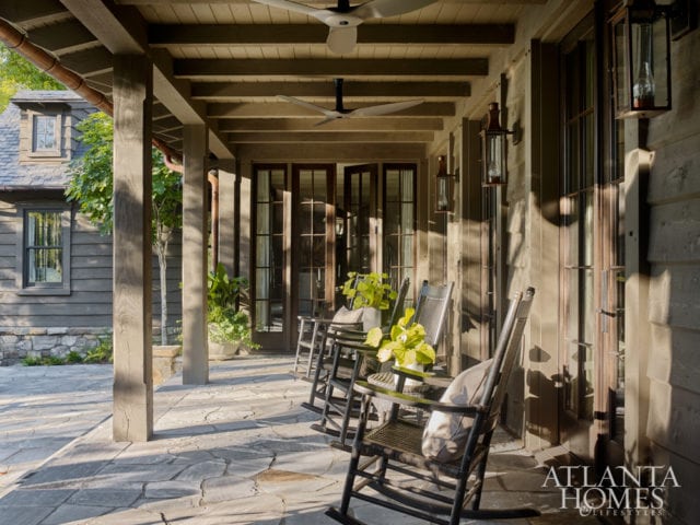 The rear porch of this lakeside home offers scenic views.