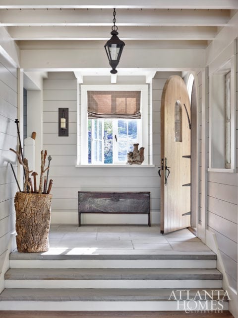 The foyer’s footprint was kept small to create a cozy entrance. It gives guests a first glimpse of the nickel joint walls that run throughout the house for a clean, classic cottage aesthetic.