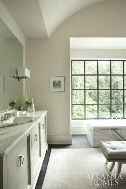 Mills Kirk had the tub and vanity countertops of the master bath clad with Manhattan marble. The bench is a Nancy Corzine design covered in Kravet leather.