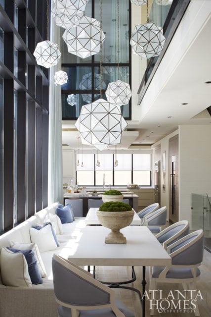 Pendant lights from Restoration Hardware dance in the atrium space and above the dining area of this New Orleans townhome.
