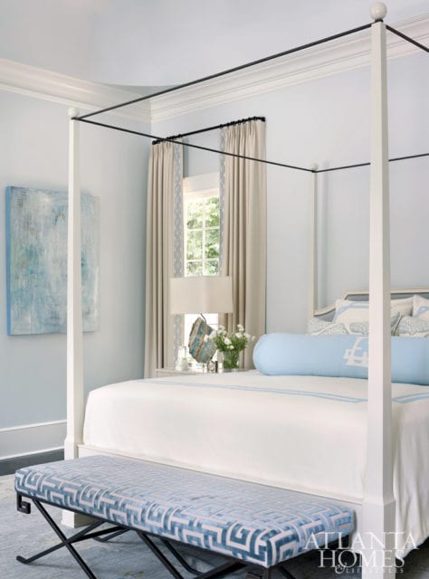 In the master bedroom, a David Iatesta bed features bedding from Leontine Linens. The drapery fabric is JAB and the trim is Travers. The abstract is by Blayne Macauley at Anne Irwin Fine Art.