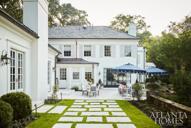 The benefits of having a skilled design-build team in place are most evident in the rear of the residence. Paces Builder Group executed Heydt’s vision of creating a connection to the outdoors via steel-and-glass doors off the family room as well as a new door in the breakfast nook bay. Landscape architect Alec Michaelides led a complete landscape overhaul to deliver a space fit for entertaining, while Bosbyshell outfitted it with furnishings from Kolo Collection and Frontgate umbrellas. Ensuring the home’s entire renovation went off without a hitch was project supervisor Wayne Mitchell of Paces Builder Group. below The tablescape features dishware by Hudson Grace.
