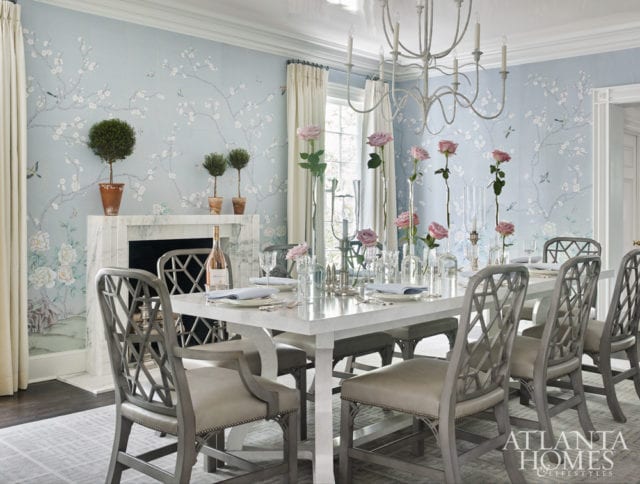 In the dining room, a high-gloss ceiling complements a chinoiserie wallpaper by Paul Montgomery through Travis & Company. The table and chandelier are David Iatesta through Ainsworth-Noah.