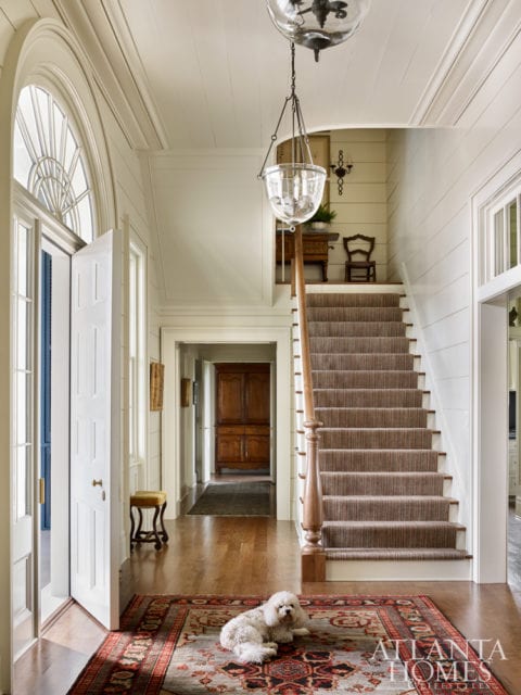 Wood planking softens the home’s formality. Carter Kay and Nancy Hooff opted to keep the millwork and walls one color, allowing the molding to become part of the architecture.