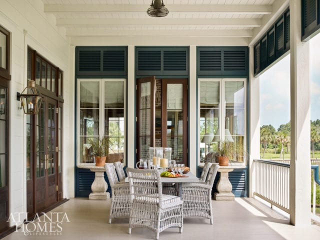 A series of mahogany doors connecting to the combination living-and-dining room not only doubles the entertaining space but gives the couple’s little loved ones more space to play and explore. The wicker chairs are from Lloyd Flanders’ Mackinac collection.