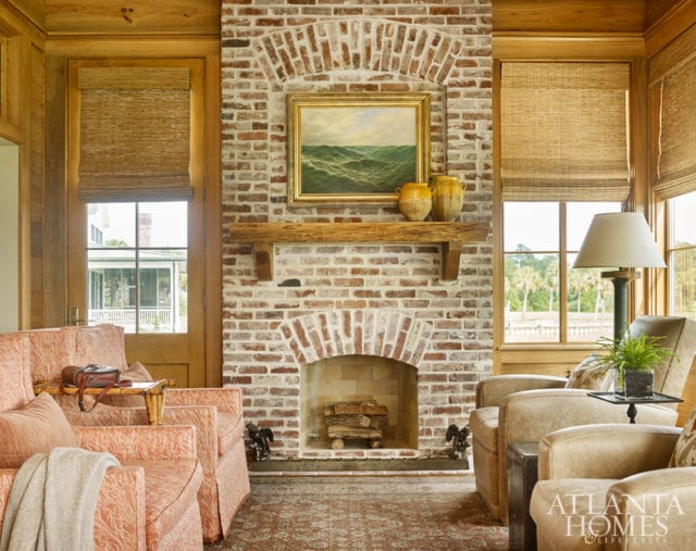 In the den, a Fortuny drapery fabric was repurposed as upholstery for new armchairs.