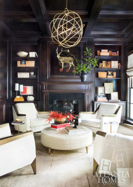 Wood and antiqued bronze Jean De Merry chairs, covered in a cream Nancy Corzine fabric, invite conversations in the ebony- paneled library.