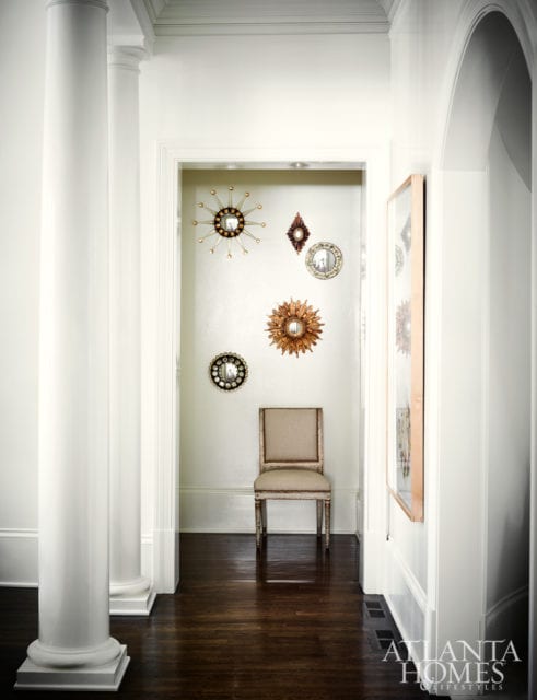 The master bedroom vestibule displays a collection of starburst mirrors.