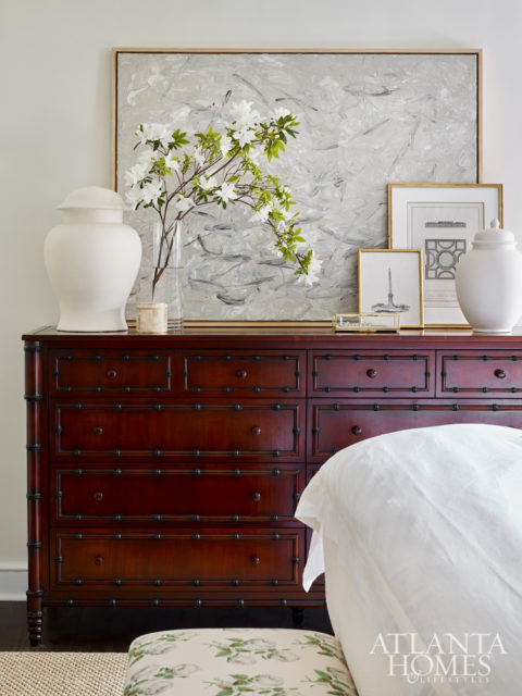 An abstract painting by McKenzie Dove represented by Pryor Fine Art rests on an English Colonial-inspired dresser from Williams- Sonoma Home.
