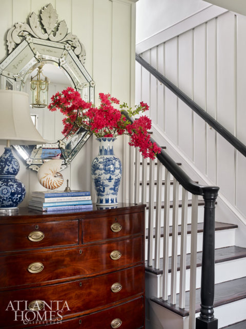 A stately mirror and chest, remnants from the previous owners, now greet visitors in the foyer.