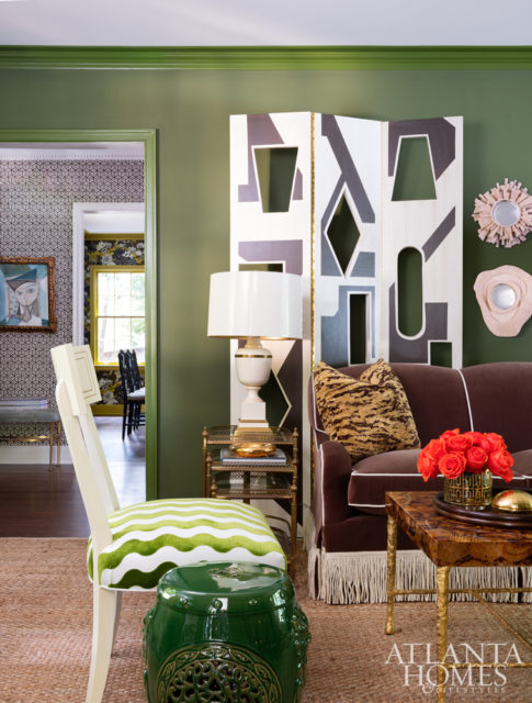 Turner created layers of interest in the salon-style living room, from leopard-print pillows and enveloping hues to graphic elements.