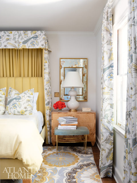 The patterned rug, draperies and bedding in the master bedroom coordinate with the wallcovering in the en suite bathroom.