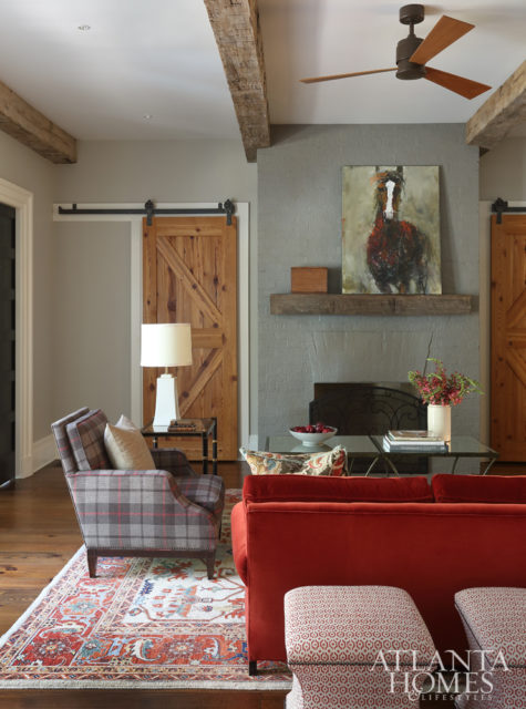 A plaid fabric by Schumacher inspired the family room’s traditional color scheme. The equine painting above the fireplace is by Susan Easton Burns, represented by dk Gallery.