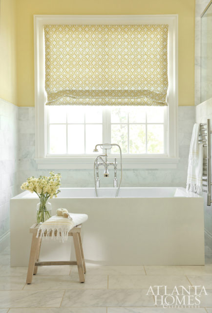 The sunny hue continues into the master bath, where a geometric textile by Stroheim adds a pop of pattern.
