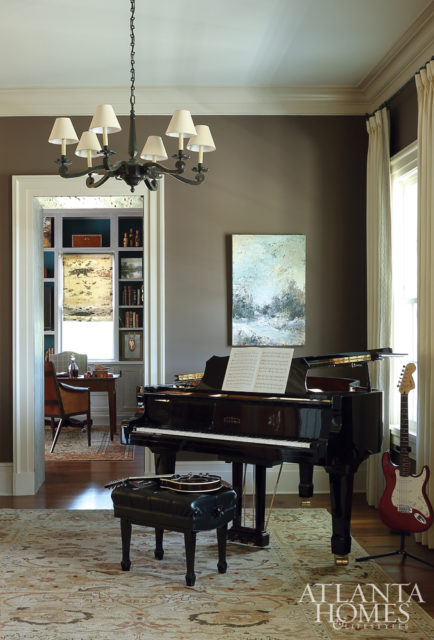 The young family enjoys spending time in the music room, which is anchored by a rug from Moattar.
