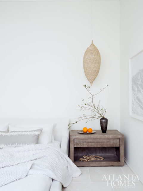 The downstairs master bedroom is awash with white.