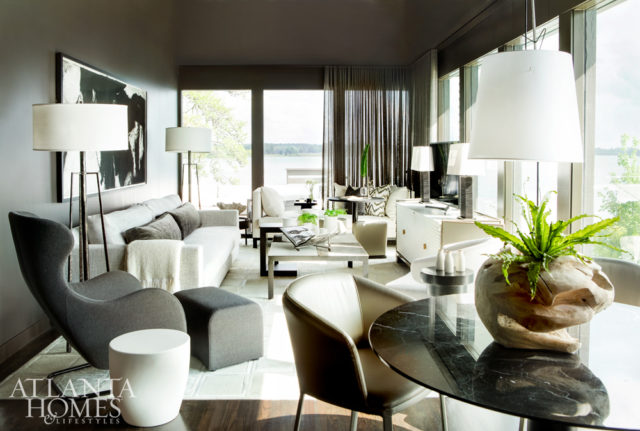 One of the home’s main gathering spaces offers plenty of room for visiting friends and family—and views to match. The floor lamps are from Revival Home and the gray lounge chair and ottoman are from Switch Modern.