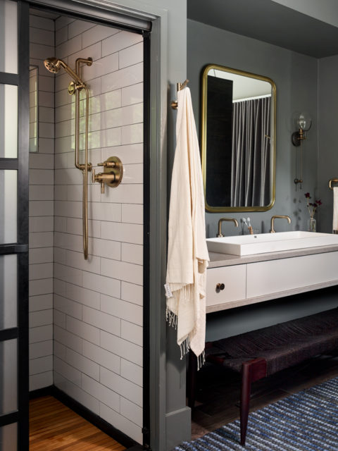 Forty-eight-inch-wide vanity sinks are helpful when accommodating visits from extended family. The showers include teak flooring and brushed brass fittings by Brizo.