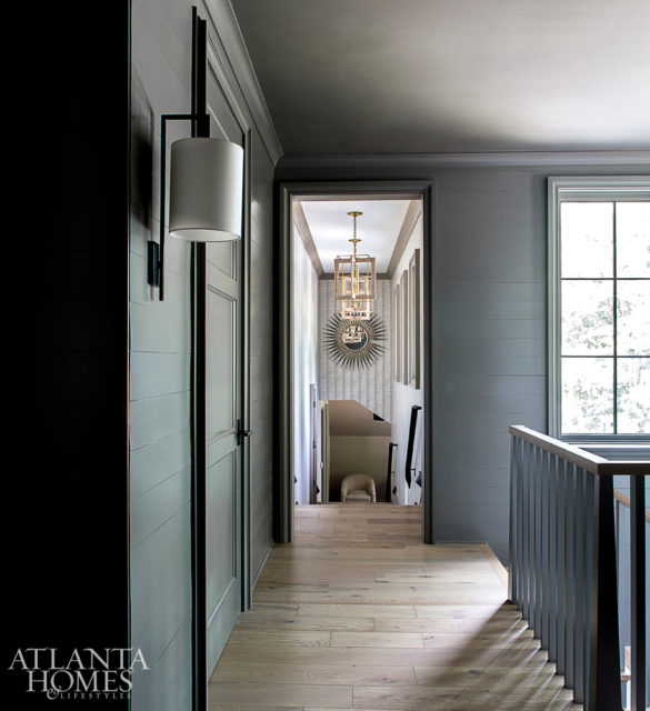 A shiplap stair hall connects the addition above the garage to the rest of the home.