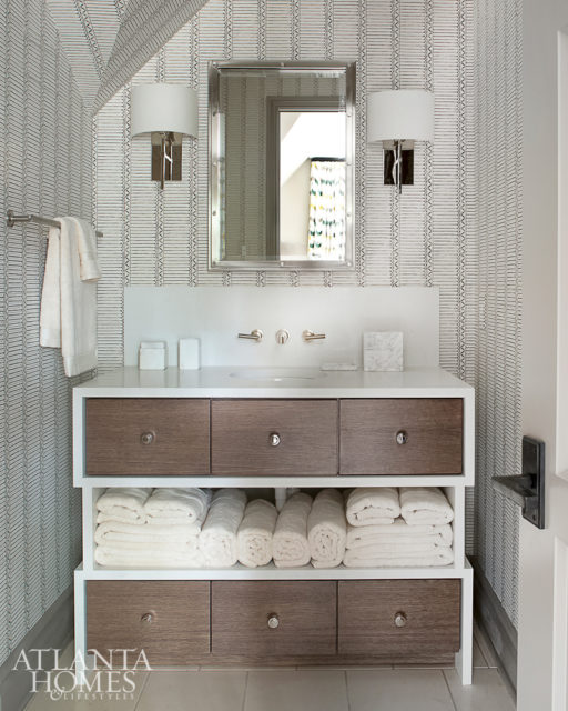 Part of the new addition above the garage, this guest suite features a pair of twin beds by Suzanne Kasler for Ballard Designs and bedding by Yves Delorme. The guest bathroom features sconces from Waterworks and a Cambria quartz vanity.