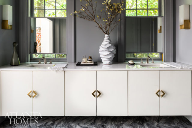 Painted Benjamin Moore’s Whale Gray, the master bathroom features a custom herringbone-cut marble and spacious floating vanity. Adjustable custom mirrors were placed within the existing windows to provide privacy without blocking natural light.