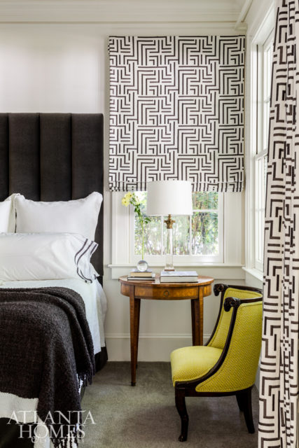 The newly added master suite was designed to feel like a retreat from the rest of the dwelling’s more public spaces. A custom bed and antique Louis XVI end tables create a bold statement. An antique chair from Parc Monceau is upholstered in a bright fabric from Jim Thompson. The drapery fabric is Camengo through Ernest Gaspard.