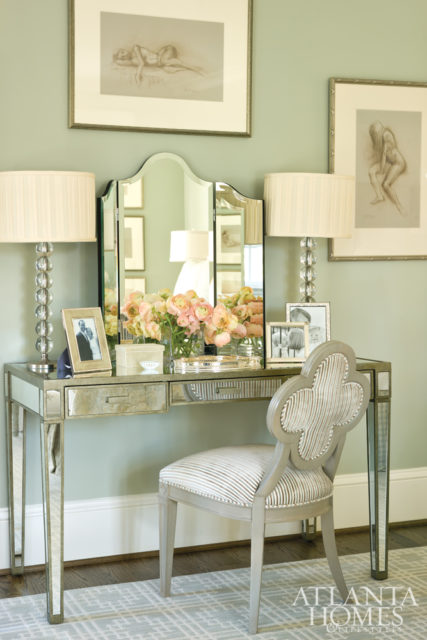 A collection of Terry Reitzel sketches and a mirrored dressing table lend an elegant flourish.