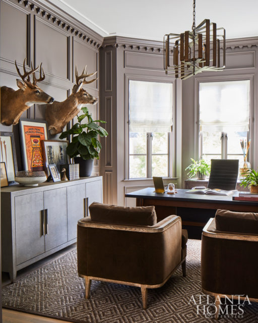 Illuminated by a modern, shapeable brass chandelier, the office is furnished with a vintage 70s-era desk from Chairish and mohair-covered chairs.
