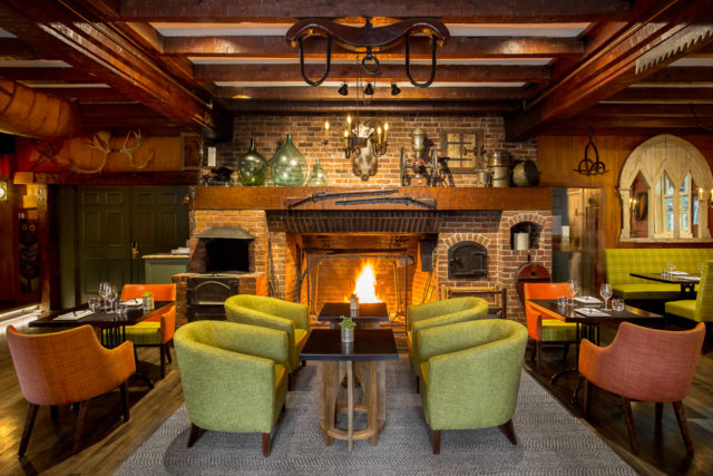 An oversize fireplace beckons at the bistro-style restaurant, Le Tap Room.